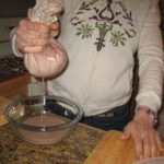 Squeezing acorn milk out of the flour.