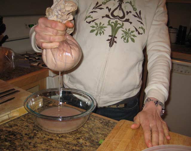 Squeezing acorn milk out of the flour.