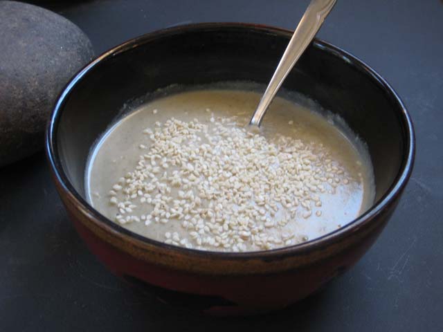 Dock Potato Tahini soup topped with sesame seeds.