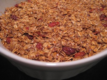 Rosehip and evening primrose seed granola pressed down into a pan, drying.