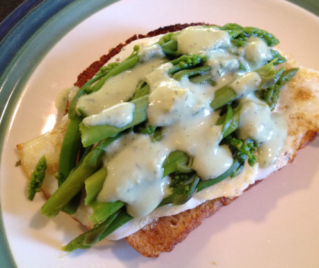 Egg on toast with wild asparagus and creamy green spruce tip yogurt dill sauce on top.