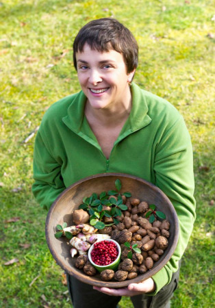 Author Ellen Zachos with a fall harvest of wintergreen, black walnuts, canna rhizomes, silverberries, and hopniss tubers. Photo by Rob Cardillo.